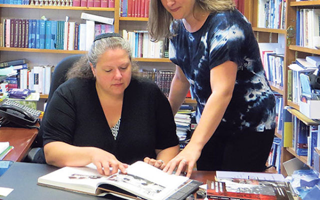 Stacy Gallin, right, discusses her proposed seminar on Nazi medical experimentation with Rabbi Melinda Panken of Temple Shaari Emeth in Manalapan.     