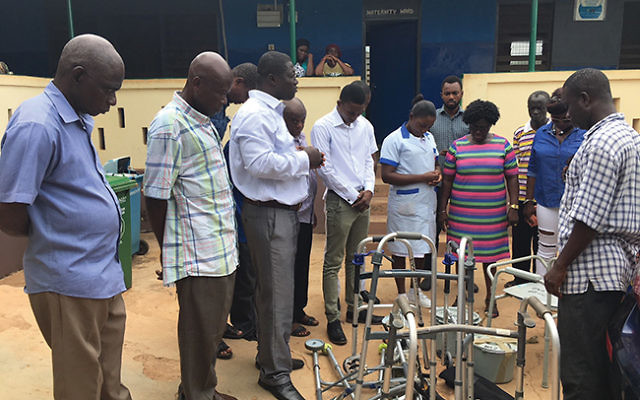 Medical staff, patients, and others in Wamfie, Ghana, offer prayers of thanks to Congregation Beit Shalom for its donation of badly needed medical equipment. Photo by Amelia Adjei