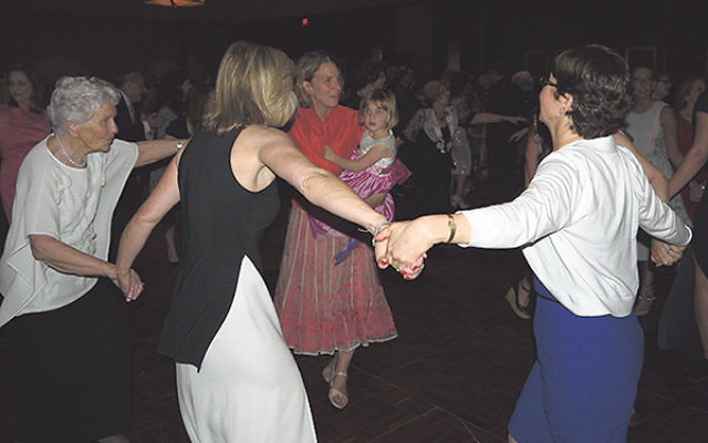 Paula Gottesman, far left, dancing at the gala with her daughter Sally (holding her daughter); Kim Hirsh, front, next to Gottesman; and others.     