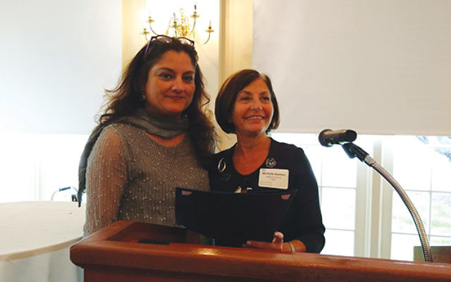 Dr. Mehnaz Afridi, left, believed to be the nation’s only Muslim director of a Holocaust and genocide education center, receives an award for her “bridge-building” efforts from Hadassah Southern NJ regional president Michelle Krasner of