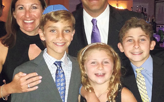 The Brandt/Popolow family at a recent bar mitzva. The boys, Alex, right, and Jacob, will celebrate becoming b’nei mitzva next spring. Their parents, Shari Brandt and Brett Popolow, are excited to take advantage of the new option for their sons; they