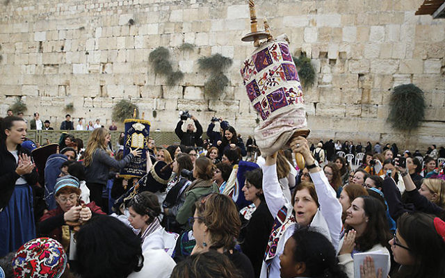 Anat Hoffman raises a Torah scroll in the women’s section of the Western Wall during a November 2016 protest. MENAHEM KAHANA/AFP/Getty Images