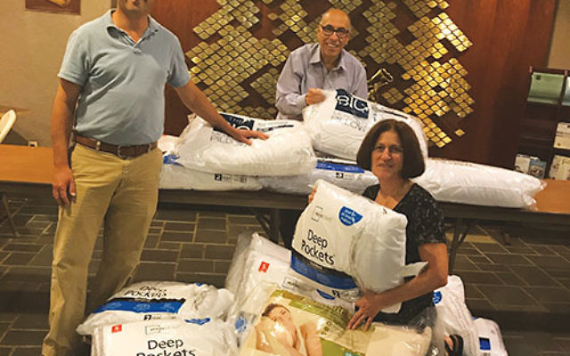 Temple B’nai Shalom in East Brunswick is collecting new wrapped pillows t for storm victims in Texas and Florida. From left are Rabbi Eric Eisenkramer, Barry Wechsler, and Dr. Iris Udasin. Photo courtesy Temple B’nai Shalom