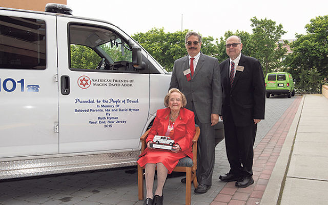 Ruth Hyman is joined in front of her newly sponsored MDA ambulance by AFMDA legacy giving adviser Jeff Lipkin, left, and AFMDA northeast regional director Gary Perl.