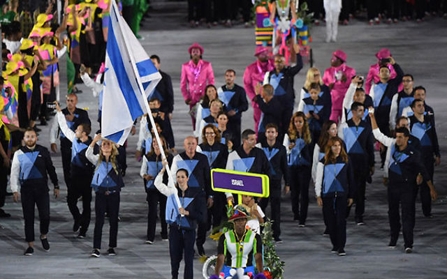 Israel’s flagbearer, Neta Rivkin, leading her delegation during the opening ceremony of the Rio 2016 Olympic Games at the Maracana stadium in Rio de Janeiro, Aug. 5, 2016. (Pedro Ugarte/AFP/Getty Images)