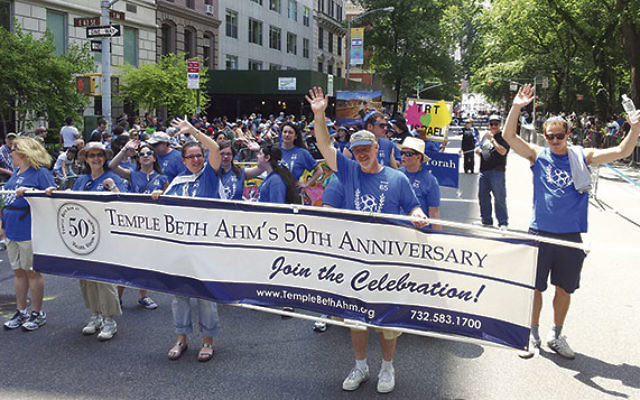 Marchers from Temple Beth Ahm, Aberdeen, pause for a picture during the 2013 parade.     