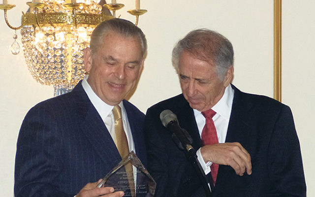 Kobi Offer, right, receives the Lilly K. Gottlieb Award from David Halpern, representing the Halpern family for whom the JFS building is named.     