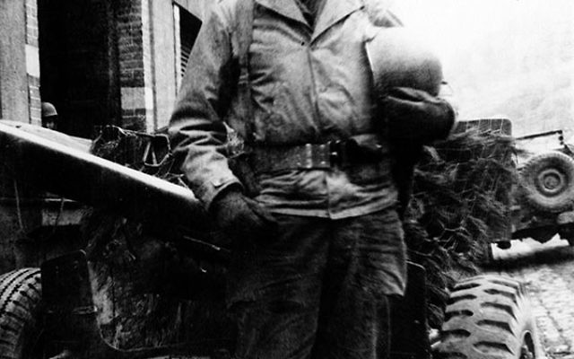 Private First Class Seymour Litwack of Newark, 19, at his jeep, prior to his participation in the Battle of the Bulge.
