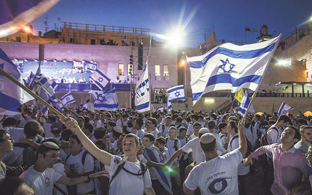 Jewish boys waving Israeli flags near the Western Wall in the Old City of Jerusalem as part of celebrations for Jerusalem Day, June 5.     