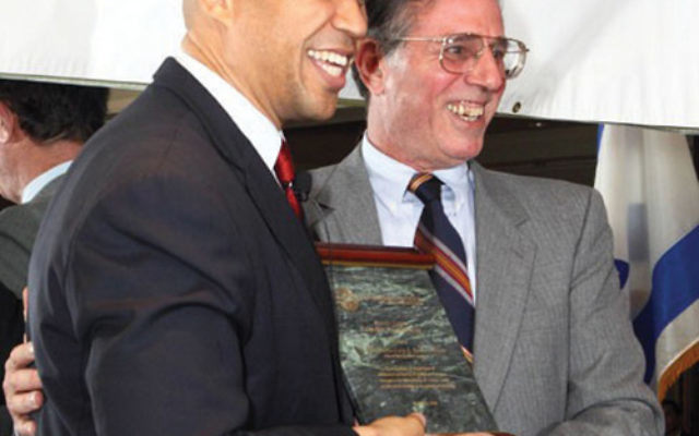 Sen. Cory Booker (D-NJ), then mayor of Newark, receives a Shomer Tzedek-Guardian of Justice Award from Lionel Kaplan, vice president for Israel and overseas for the Jewish Federation of Princeton Mercer Bucks, on November 2010. Photo by Debra Rubin