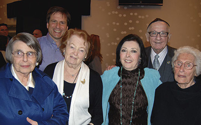 At the Yom Hashoa commemoration at Kean University are honoree Dr. Paul Winkler, right, Barbara Wind, second from right, and, from left, survivors Gerda Bikales (with her son Eddy behind her), Marsha Kreuzman, and Anitta Fox.    