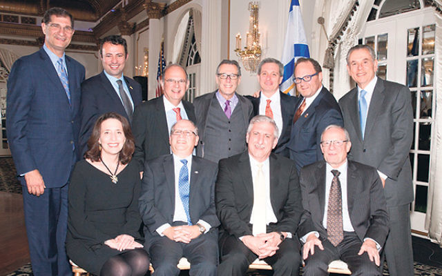 Guests of honor Max Kleinman, seated, center, left, and David Lentz, center, right, are flanked by Leslie Dannin Rosenthal, president, Jewish Federation of Greater MetroWest NJ; Izzy Tapoohi, Israel Bonds president & CEO and, standing, from left, Larr