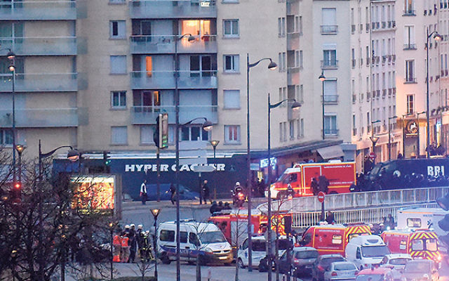 Police arrive at the Hyper Cacher kosher market, where the hostages were being held, Jan. 9.     