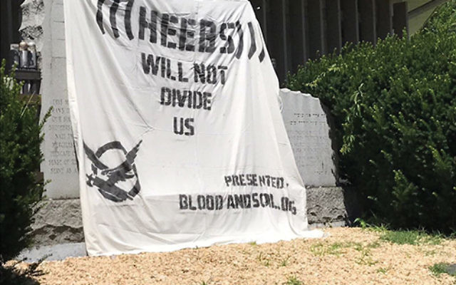 An anti-Semitic banner covered a Holocaust memorial at Congregation Sons of Israel in Lakewood. Photo courtesy The Lakewood Scoop