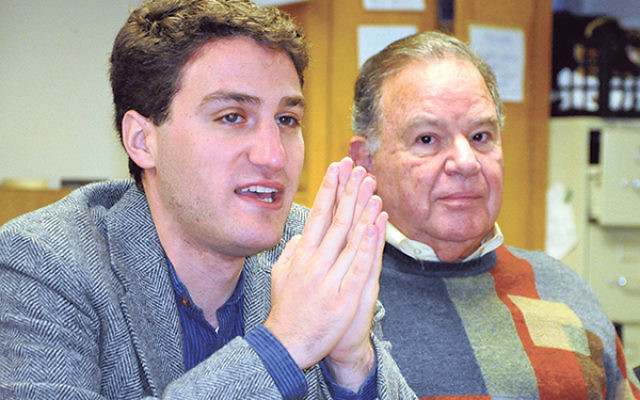 Jacob Levkowicz, left, addresses the gathering as Herb Horowitz, past president of the AJC Central NJ chapter, listens.