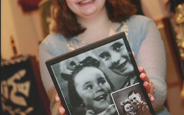 Ariella Livstone, who celebrated her bat mitzvah in March, holds a photo of Lucie Lipstein, a Belgian child murdered in Auschwitz who was paired with Ariella by the Remember a Child project of The Generation After. Photo by Barry Korbman