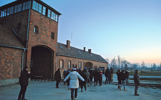 Students gather outside the gates of Auschwitz in Poland.