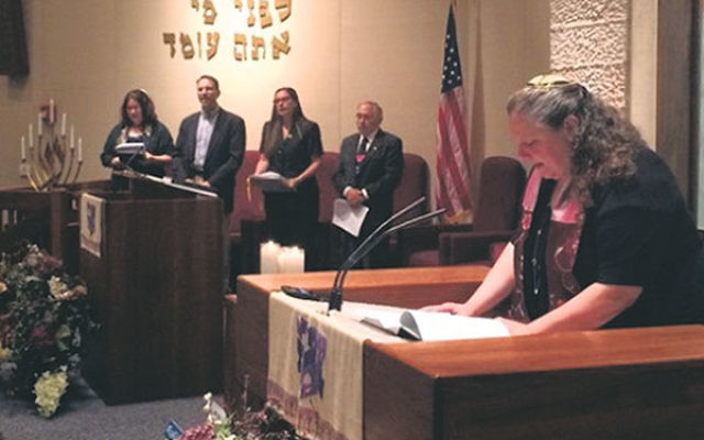 At Shaari Emeth, Rabbi Melinda Panken, right, leads the gathering in prayer along with, from left, Cantor Gabrielle Clissold, Rabbi Michael Pont, Rabbi Lisa Malik, and Rabbi Michael Klein.