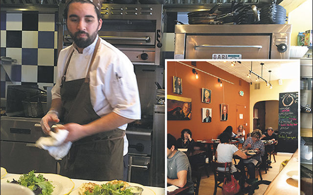 Diners dig in as chef Meny Vaknin works in the open kitchen at Mishmish.