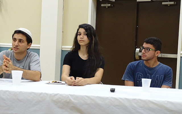 Steven Aiello, left, creator of Debate for Peace, and Israeli teenage participants Khetam Kalash, center, and Omri Weinstock describe the benefits of the program at White Meadow Temple in Rockaway. Photo by Robert Wiener