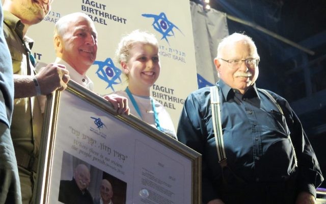 Molly Dodd is welcomed as the 500,000th Taglit-Birthright participant at a Tel Aviv ceremony by, left to right, Taglit-Birthright CEO Gidi Mark, and co-founders Charles Bronfman and Michael Steinhardt.
