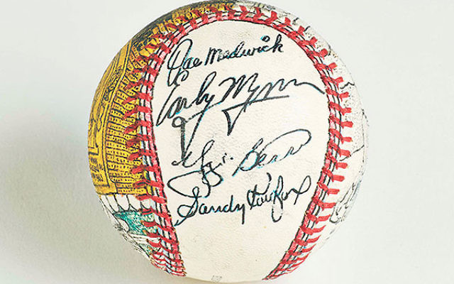 This custom baseball signed by Sandy Koufax and other Hall of Famers, including Yogi Berra, is a prized possession in the Jeff Aeder collection.      