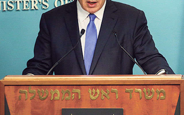 Prime Minister Benjamin Netanyahu speaks to the press from his office in Jerusalem following the finalization of a nuclear deal with Iran, July 14.     
