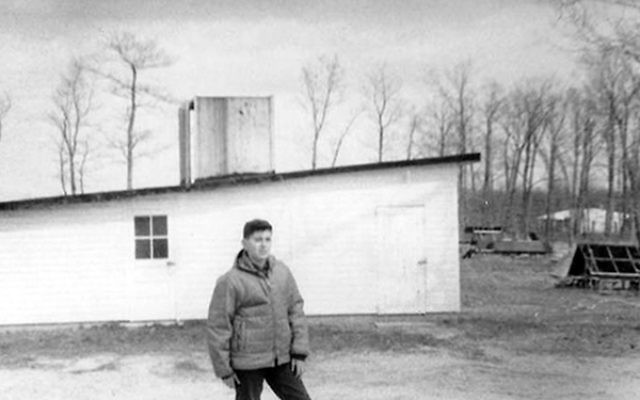 Michael Kirschenbaum in front of the brooder coop on the farm on Friendship Road in Howell, 1966.