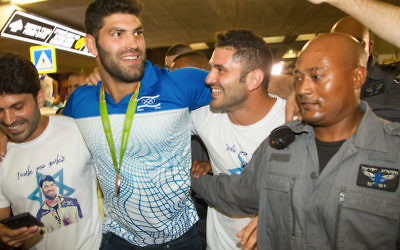 Israeli judoka Ori Sasson, second from left, arriving at Ben Gurion Airport near Tel Aviv, Aug. 15, 2016.