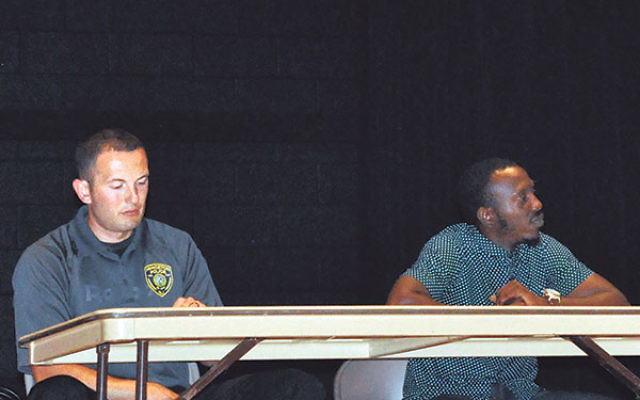 At a July 27 gathering in Princeton, police officer Bill Kieffer, left, said training of officers about racial profiling and cultural diversity is critical; Tone Bellamy told the gathering, “It is not normal for a black man and a white cop to feel c