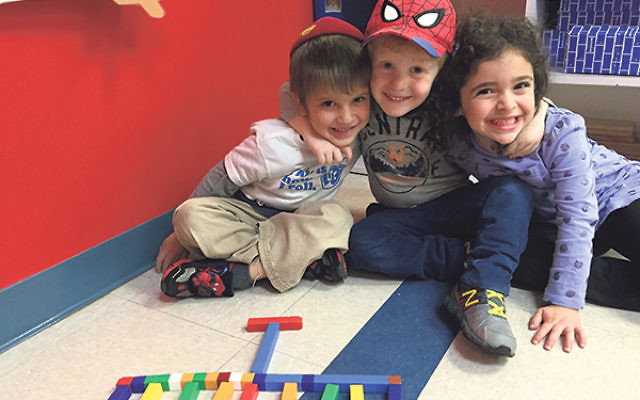 Children in the pre-K class at RPRY celebrate Hanukka by building a menora with blocks.