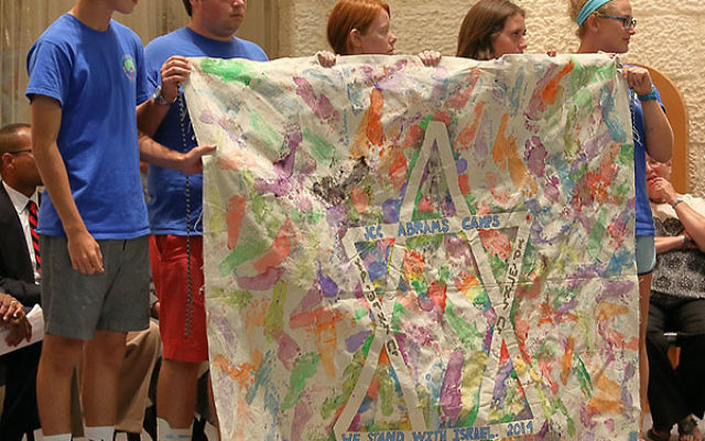 Youngsters from JCC Abrams Camps display a banner at the Israel solidarity rally.