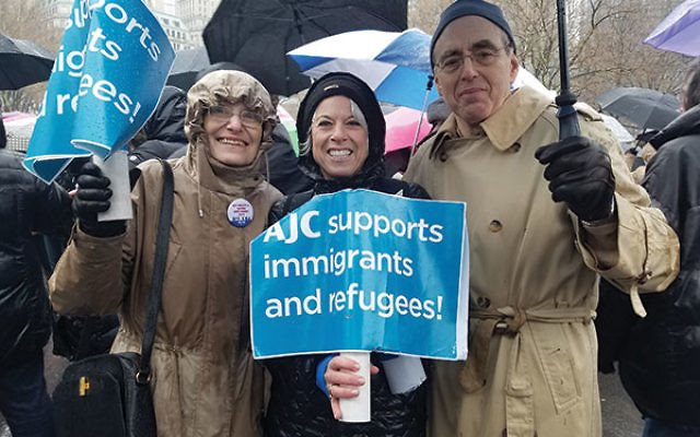Rally-goers from the American Jewish Committee’s Central NJ region, from left, Rysia de Ravel, Lori Feldstein, and Peter Gelb, gather in the rain in Battery Park.