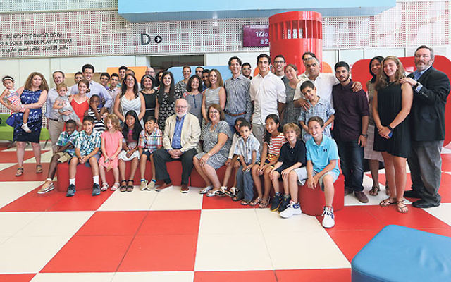 Dr. Sol and Meri Barer, center, with family members, patients, and staff at the inauguration of the pediatrics inpatient department bearing their name.