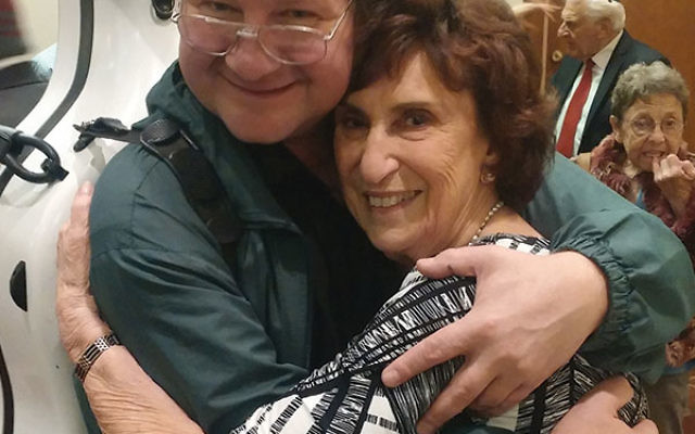 Oheb Shalom Congregation member Sheila Appel gets a thank-you hug from Andrey Tchekmazov, whose family she helped settle in South Orange.