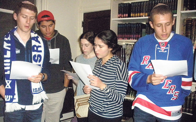 Students at Rutgers Hillel recite tehillim (psalms) for Israel in the wake of recent terrorist attacks. 