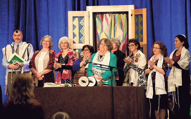 Rabbi Sally Priesand, front and center, is honored with an aliya at the 2012 Central Conference of American Rabbis convention in Boston as she celebrates 40 years since her ordination as a rabbi, surrounded by other women rabbis. 
