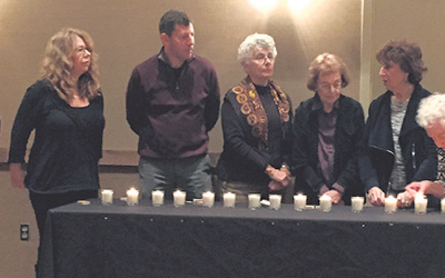 Members of Oheb Shalom Congregation in South Orange lit candles and recited prayers Dec. 3 in the wake of the San Bernardino shooting. The ceremony took place during the second in a series of three programs on gun violence; the film, Living for 32</em