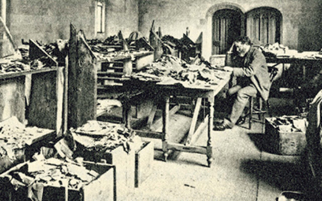 Solomon Schechter at his desk at Cambridge University studying ancient documents from the Cairo Geniza at Ben Ezra Synagogue.    