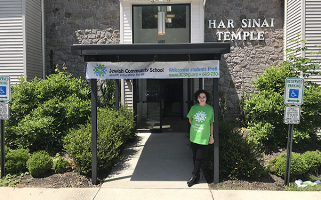 Magda Reyes, director of the new Jewish Community School, stands in front of the school which will meet in the buildings of Har Sinai and Adath Israel. Photo by Michele Alperin