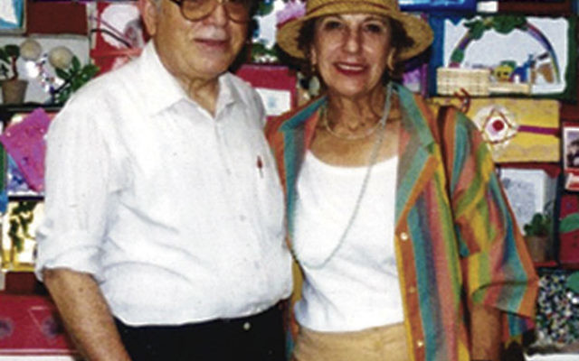 Rabbi Joseph Maza and his wife, Shirley, in 1996 by a bulletin board at Congregation Anshe Emeth celebrating the 3,000th anniversary of Jerusalem.