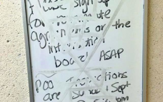 Two swastikas and an X were smeared on a whiteboard outside a Kean University dorm room last October. Photo by Nathaniel Sietz
