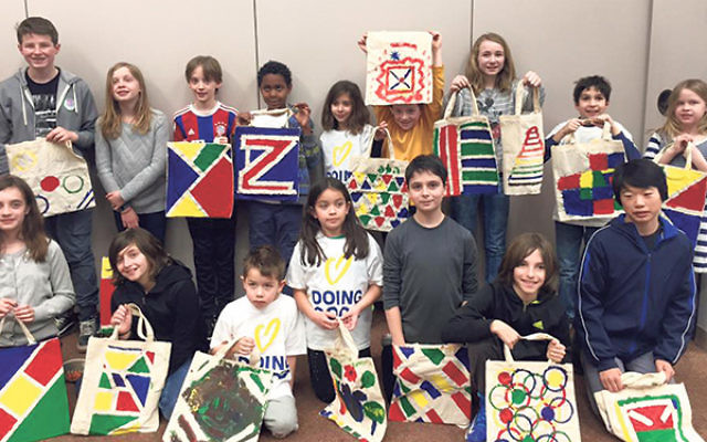 Tikkun Olam Tour participants display the bags they painted for Leket, Israel’s largest food bank.