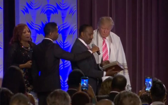 Donald Trump receiving a tallit from Bishop Wayne Jackson of the Great Faith Ministries in Detroit, Sept. 3, 2016 (Screenshot from YouTube)