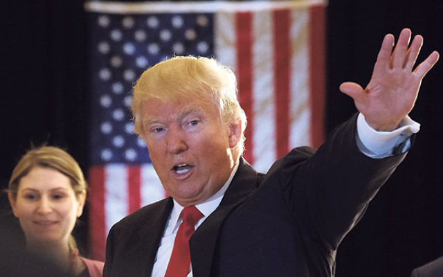 Donald Trump waving after a news conference at the Trump Tower in New York, May 31.  