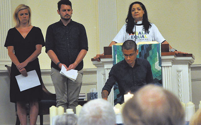 The Rev. Karen Hernandez-Granzen of Westminster Presbyterian Church in Trenton and members of the Princeton Theological Seminary student group BGLASS (Bisexual, Gay, Lesbian, and Straight Supporters) recite the names of Orlando victims and light candles i