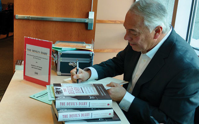 Robert Wittman signs copies of his book detailing his search and recovery of the diary of Alfred Rosenberg, a leading architect of the Third Reich who “in some respects turned Hitler into Hitler.”