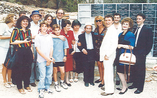 Michael Zeiger, front row, third from right, and other family members with Anton Suchinski, center, in Yad Vashem’s Garden of the Righteous, the Wall of Honor, which bears his name, behind them, 1992.