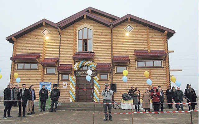 Jewish refugees in Anatevka celebrate the opening of the community’s new synagogue, Feb. 29.    