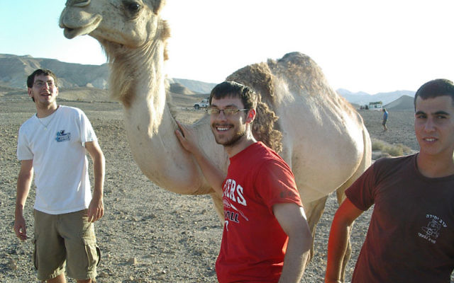 Yossi Mason, center, and fellow counselors meet one of the denizens of the Negev while on a Kefiada trip to Israel.